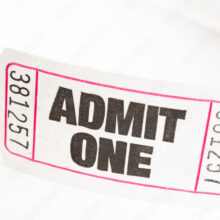 Close-up view of a ticket displaying the text "admit one