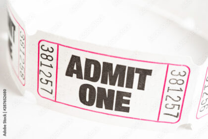 Close-up view of a ticket displaying the text "admit one