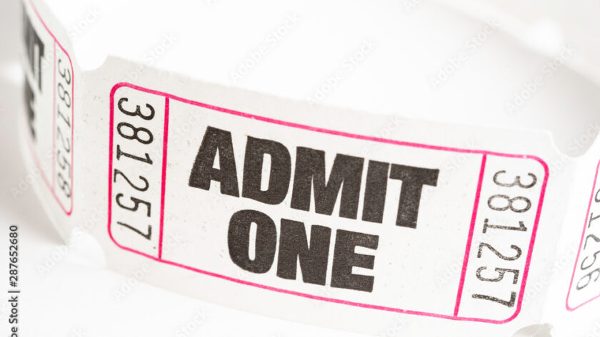Close-up view of a ticket displaying the text "admit one