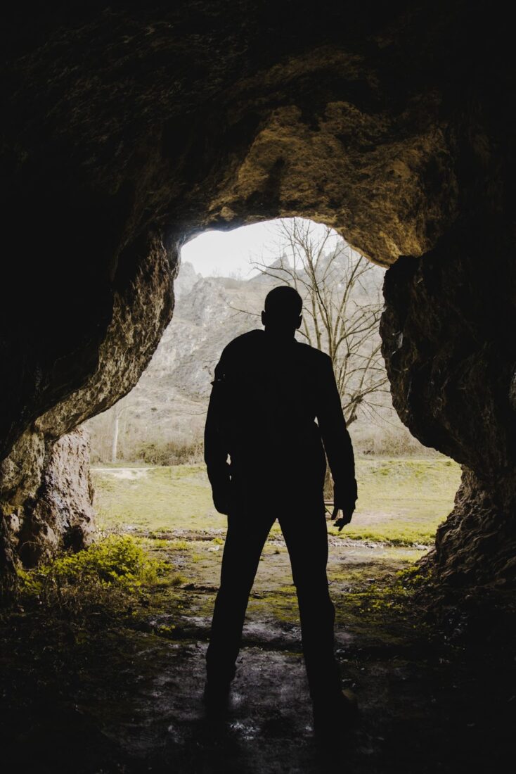 Man standing at the entrance to the cave