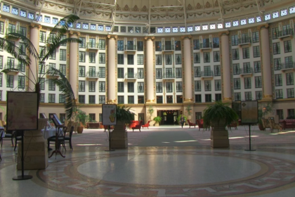West Baden Springs Hotel with flowers, tables, and chairs in it