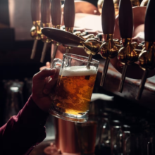 Person brewing beer from side view using a machine.