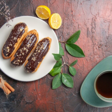 Сhoco Eclairs Inside Plate on a Dark Table