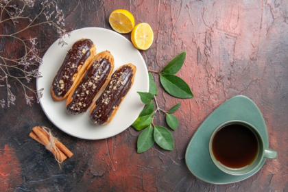 Сhoco Eclairs Inside Plate on a Dark Table