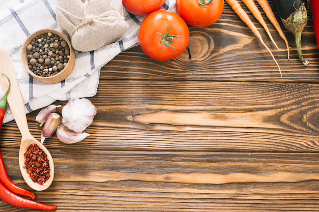 Tomatoes, garlic, and herbs displayed on a table