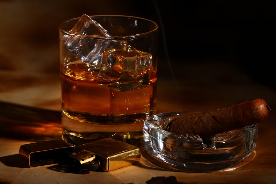 A glass of whiskey set against a dark backdrop