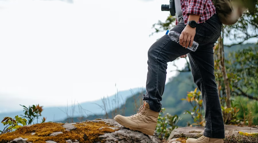 Close-up of foot and hand holding a visible water bottle