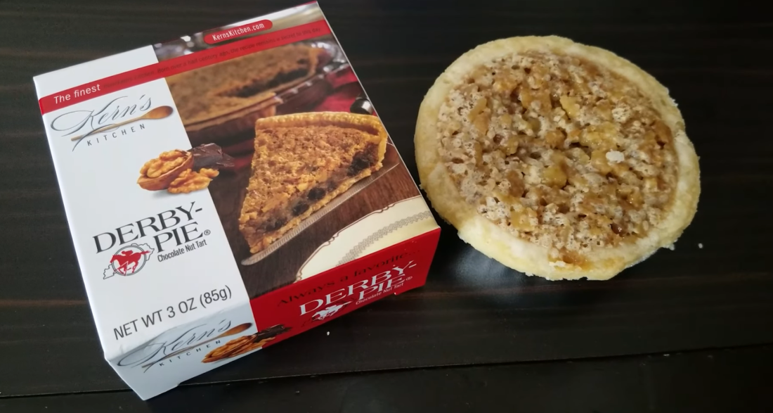 a box of derby pie and a pie on the right side on the table