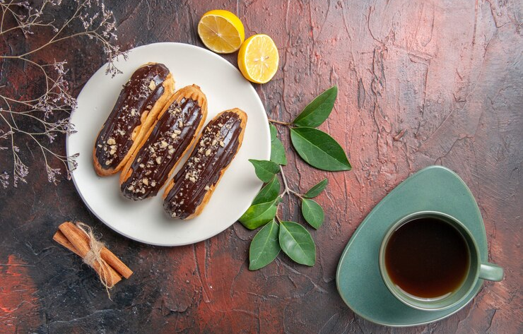 Сhoco Eclairs Inside Plate on a Dark Table
